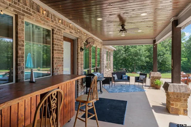 a aerial view of a house with swimming pool and big yard