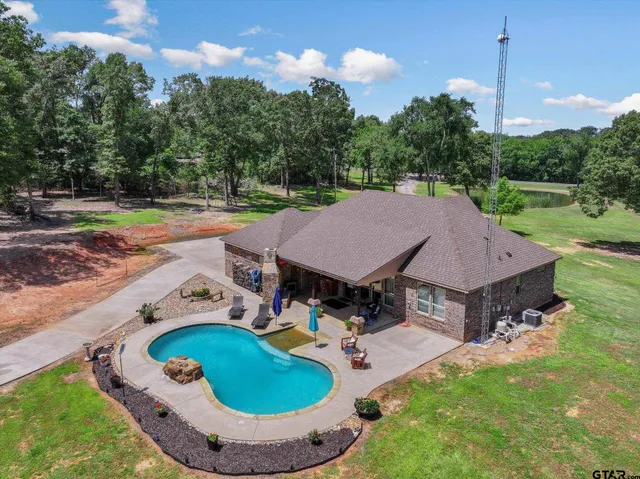 a living room with patio furniture and a fireplace