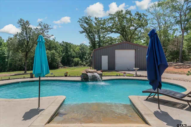 a view of a house with swimming pool and sitting area