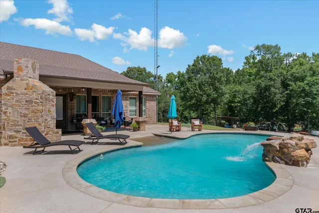 a view of a swimming pool with a yard