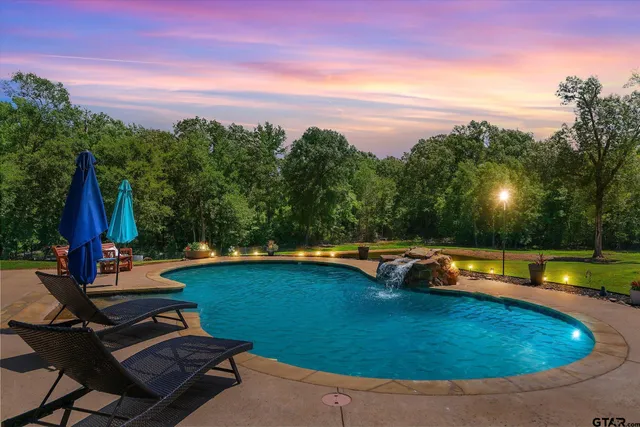 a view of a swimming pool with lounge chairs