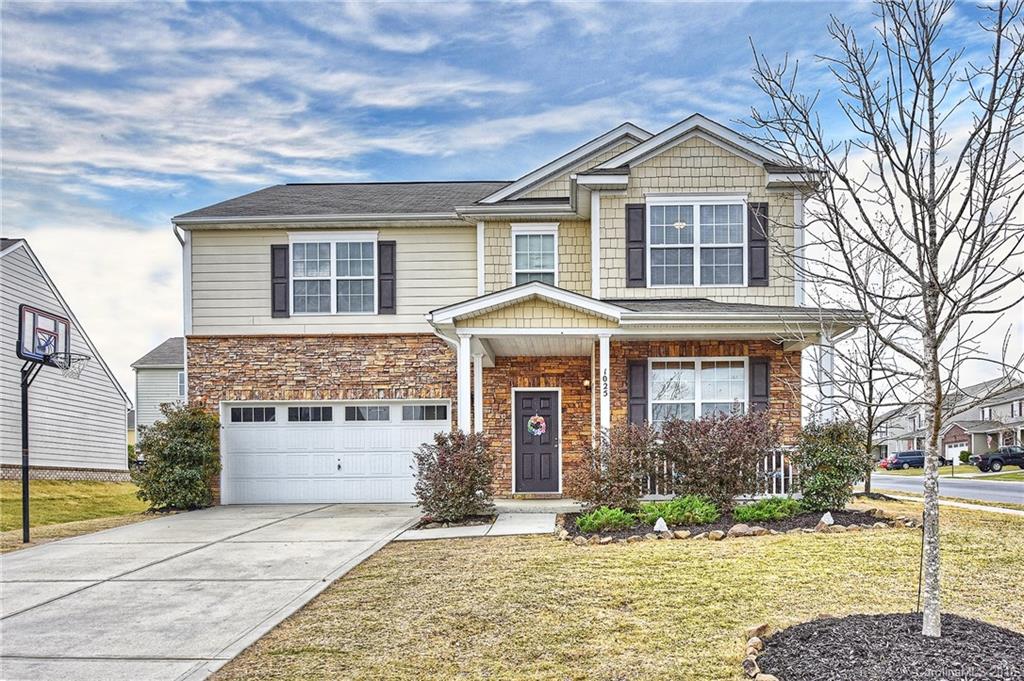 1025 Skillbeck Road Indian Trail, NC 28079 - Photo 2 of 24 a front view of a house with a yard and garage