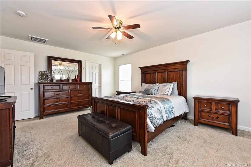 1025 Skillbeck Road Indian Trail, NC 28079 - Photo 16 of 24 a bed room with a bed and a dresser