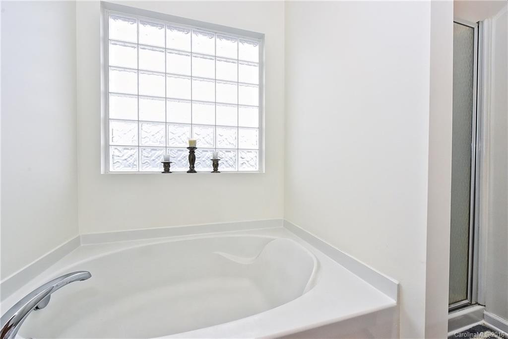1025 Skillbeck Road Indian Trail, NC 28079 - Photo 18 of 24 a white bath tub sitting next to a window