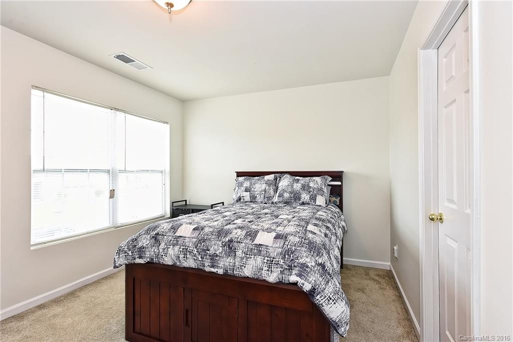 1025 Skillbeck Road Indian Trail, NC 28079 - Photo 21 of 24 a bed sitting in a bedroom next to a window