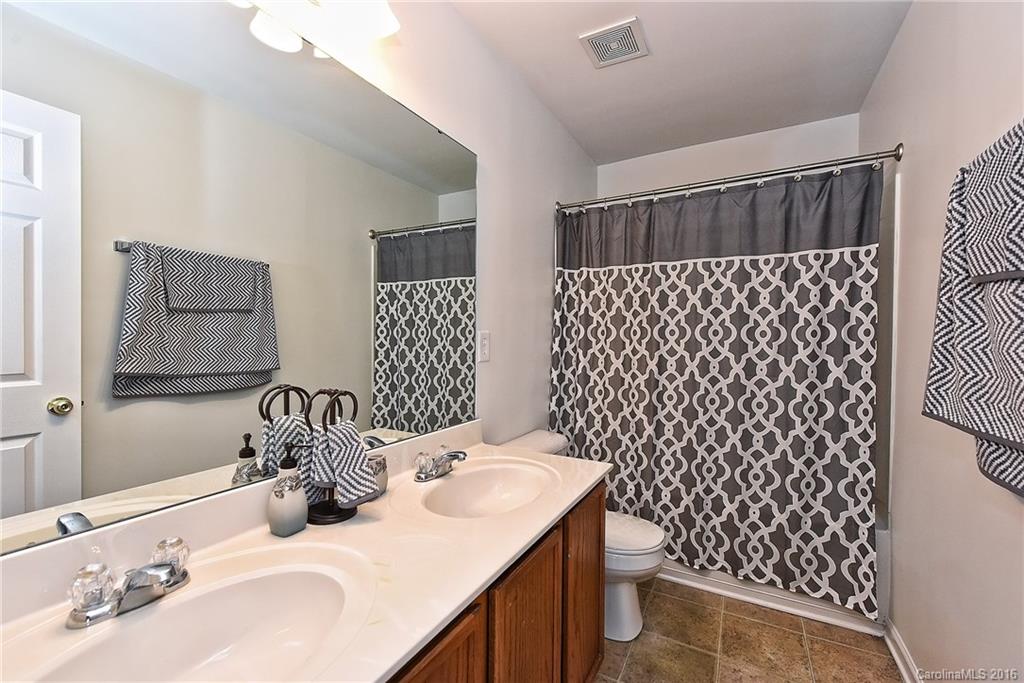 1025 Skillbeck Road Indian Trail, NC 28079 - Photo 22 of 24 a bathroom with a sink and a mirror