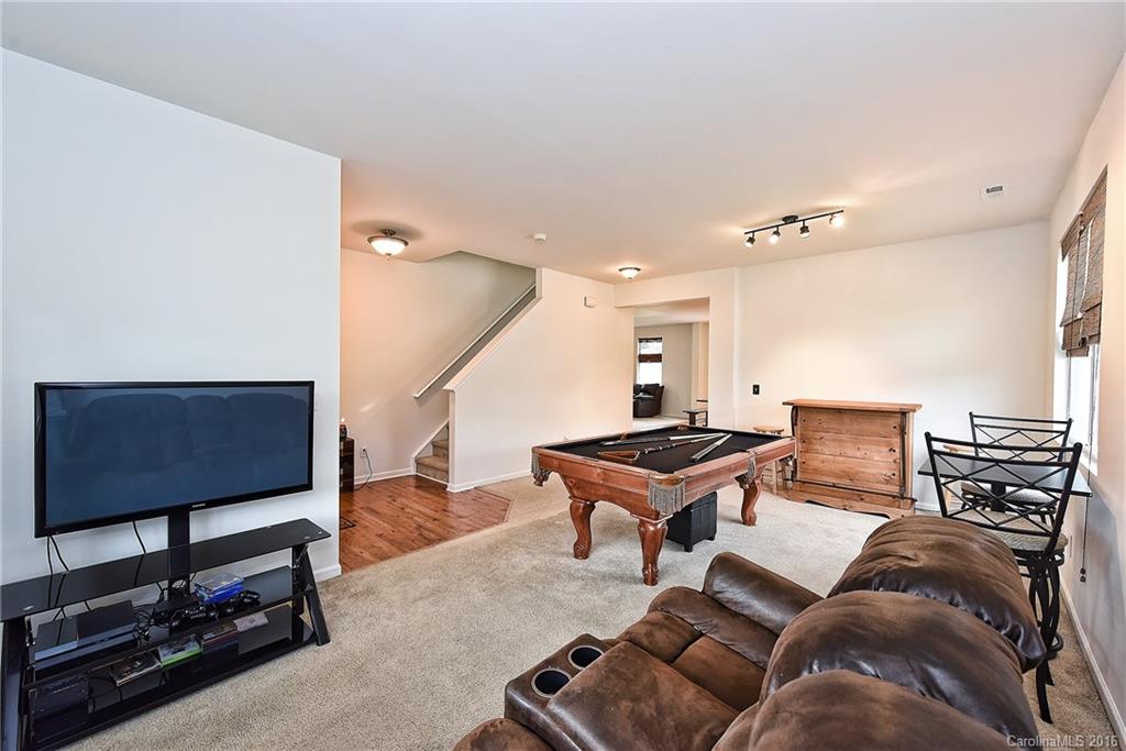 1025 Skillbeck Road Indian Trail, NC 28079 - Photo 6 of 24 a living room with furniture and a flat screen tv