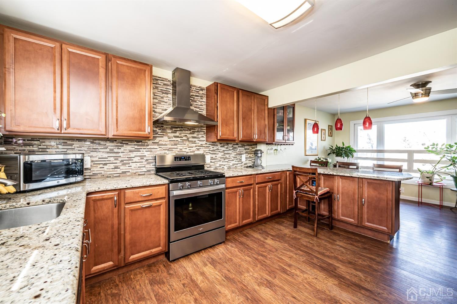 107 Estates Road Clementon, NJ 08021 - Photo 8 of 31 a kitchen with granite countertop a stove top oven sink and cabinets