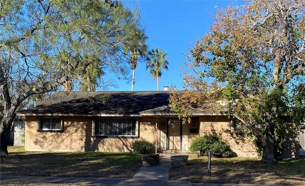 a view of a backyard with large trees