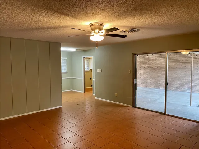 a view of an empty room with a chandelier