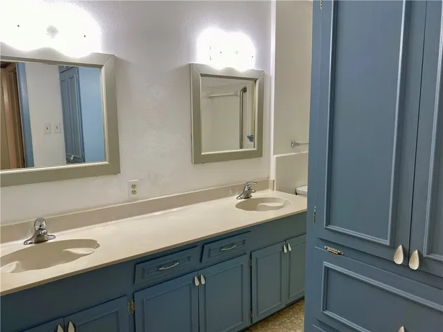 a bathroom with a sink double vanity and a mirror