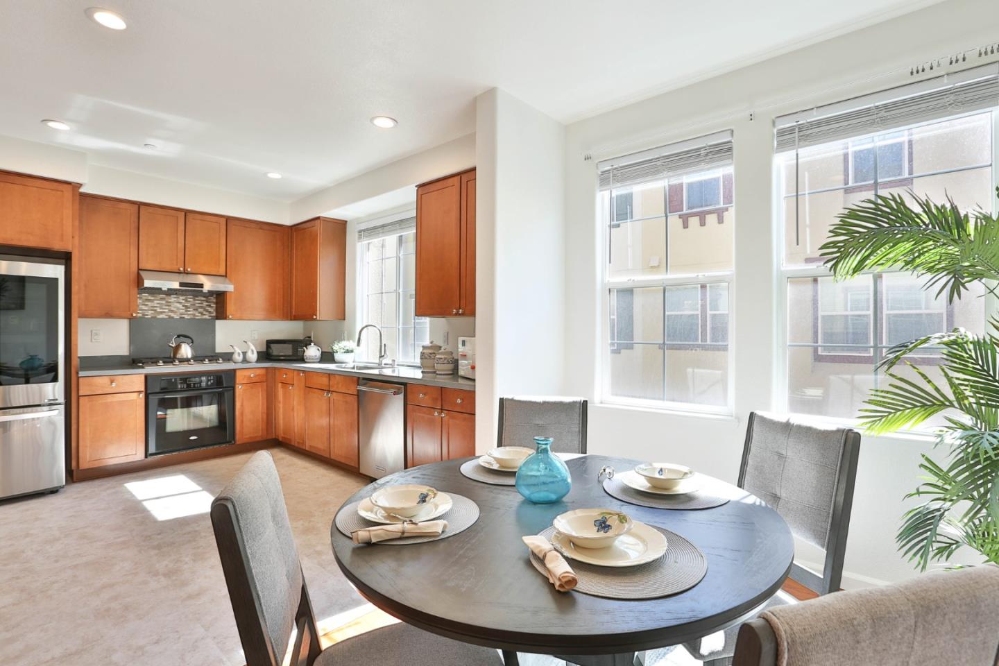 1105 Luz Del Sol Tr Loop Milpitas, CA 95035 - Photo 12 of 34 a living room with stainless steel appliances kitchen island granite countertop a dining table and chairs