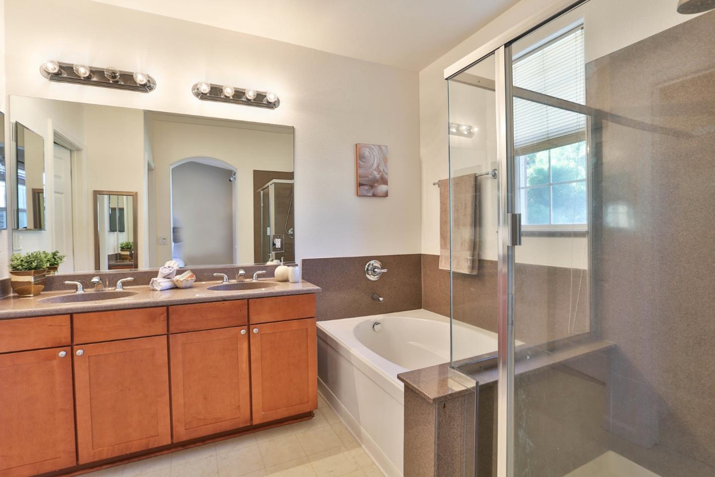 1105 Luz Del Sol Tr Loop Milpitas, CA 95035 - Photo 14 of 34 a bathroom with a sink a mirror and a shower