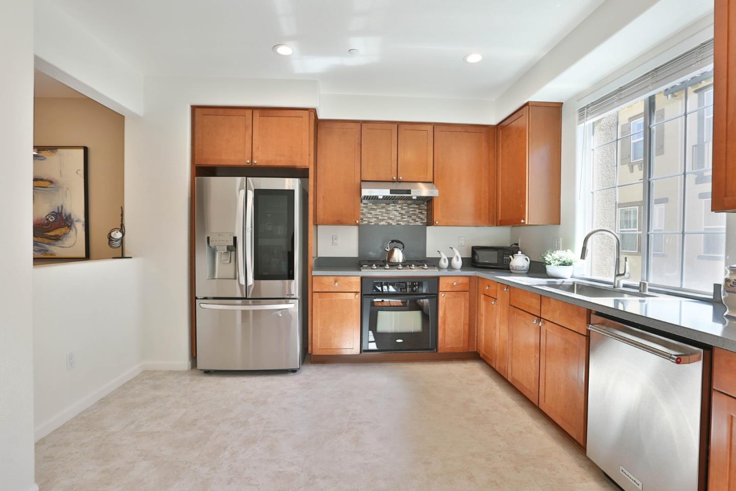 1105 Luz Del Sol Tr Loop Milpitas, CA 95035 - Photo 10 of 34 a kitchen with stainless steel appliances granite countertop a refrigerator and a sink
