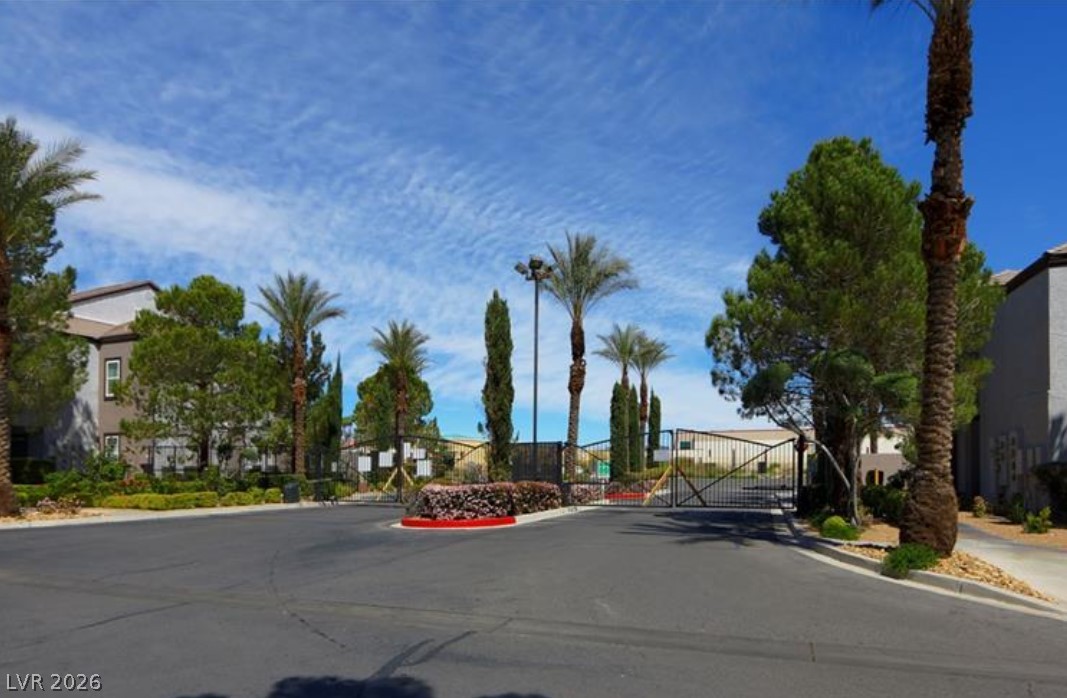 7255 West Sunset Road, Unit 2111 Las Vegas, NV 89113 - Photo 32 of 33 Secure community entrance featuring a robust gated entry and mature desert landscaping.