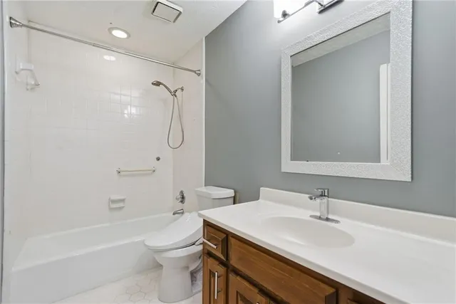a bathroom with a sink toilet vanity and shower