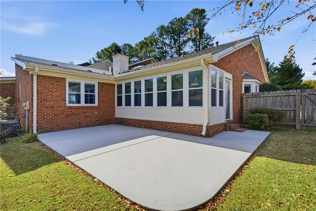 a view of a house with wooden deck and furniture