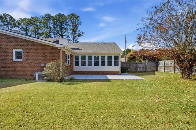 a view of a house with a yard patio and fire pit