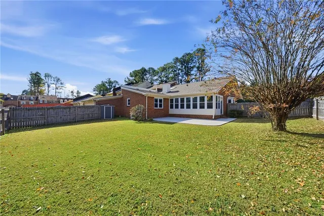 a view of a swimming pool with an outdoor seating and a garden