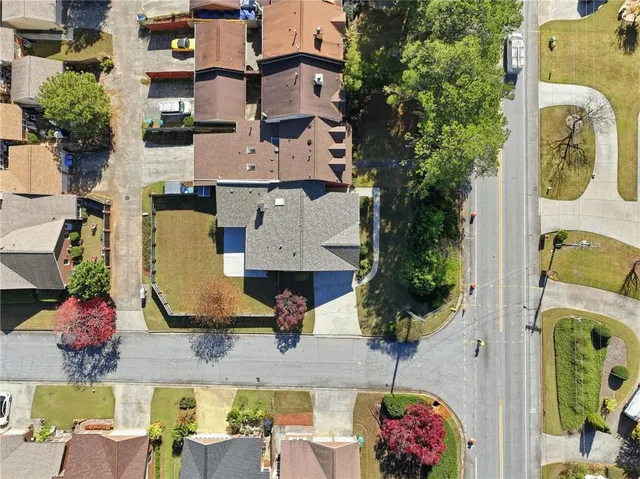 an aerial view of residential houses with outdoor space and parking