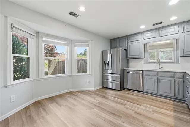 a kitchen with granite countertop a refrigerator and a sink
