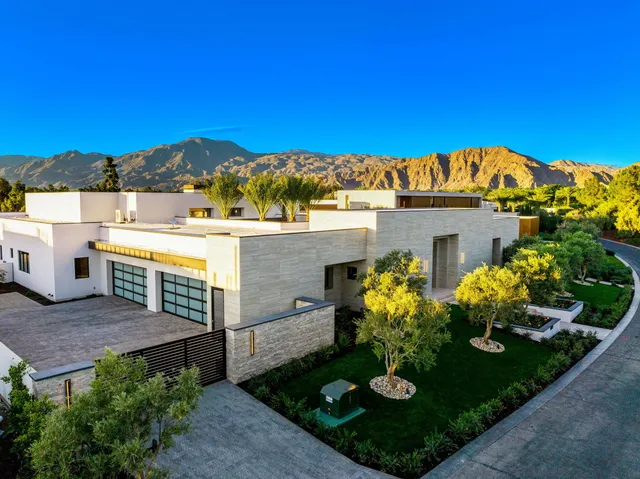 a view of a patio with table and chairs and potted plants