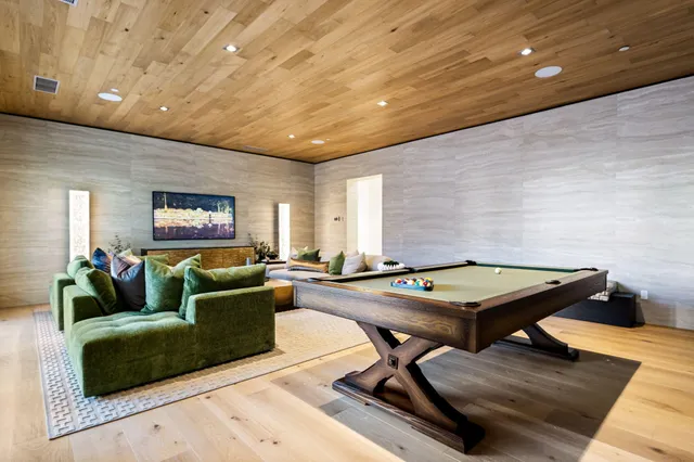 a living room with furniture and a floor to ceiling window