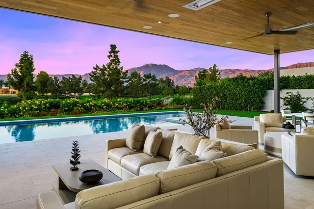 a swimming pool with outdoor seating and yard