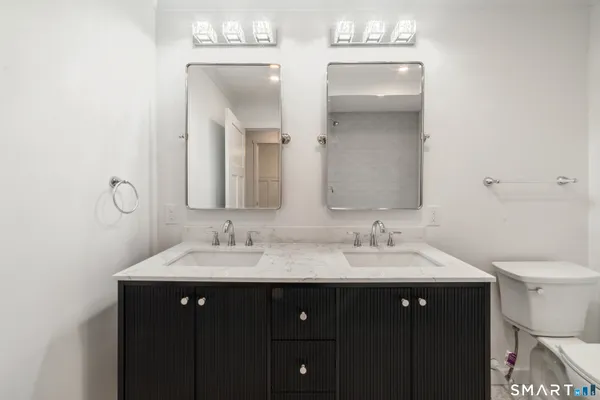 a bathroom with a double vanity sink and a mirror