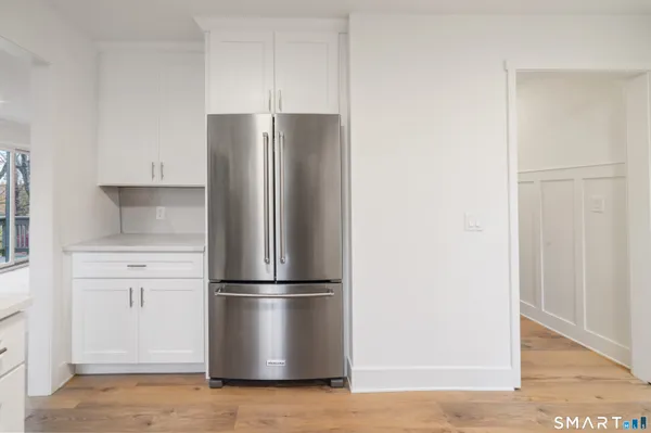 a metallic refrigerator freezer sitting in a kitchen