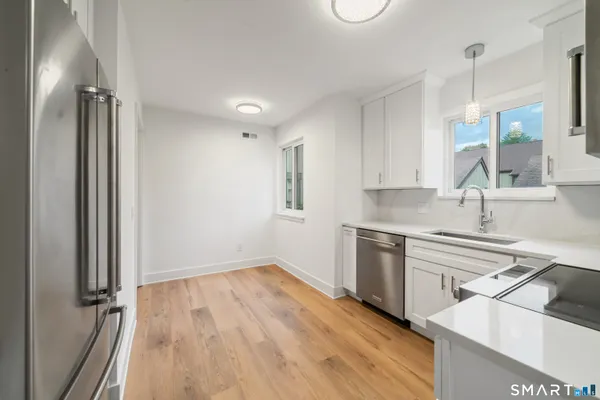 a kitchen with a sink stove and refrigerator