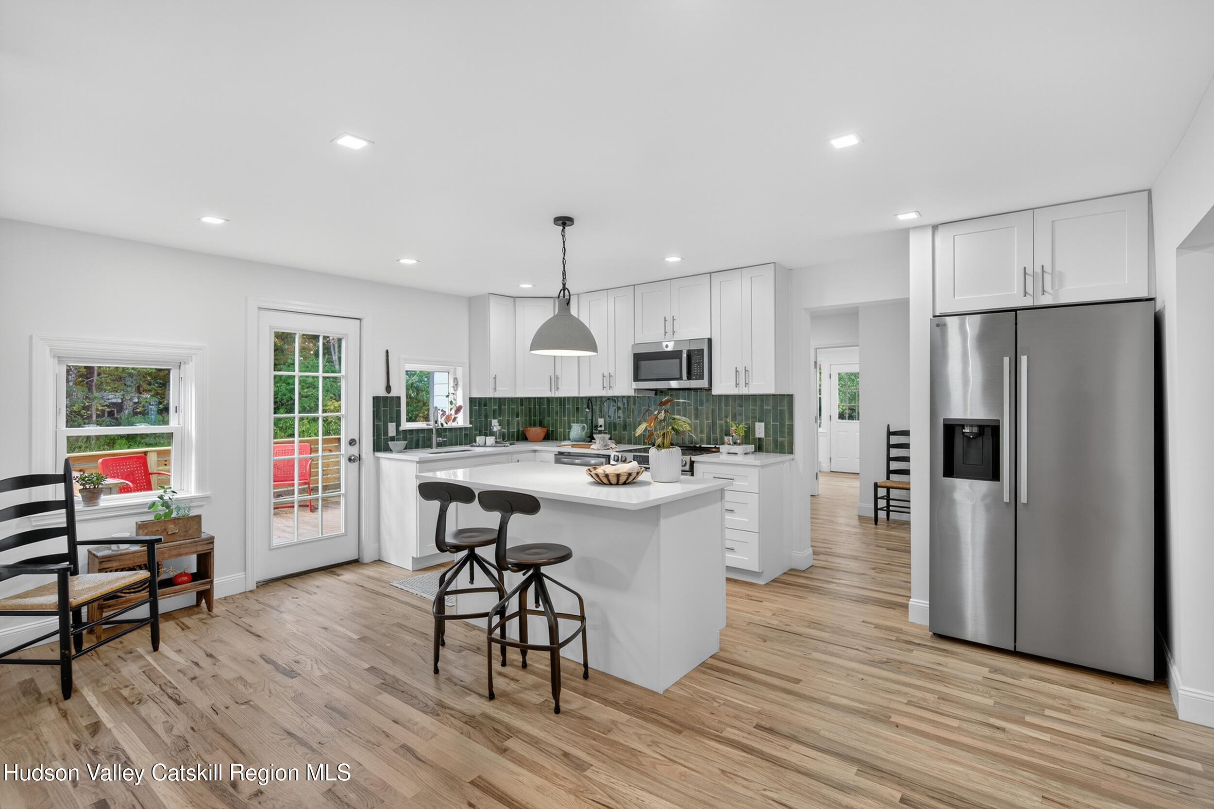 70 Fawn Road Saugerties, NY 12477 - Photo 13 of 30 a kitchen with a refrigerator a stove top oven a sink dishwasher and white cabinets with wooden floor