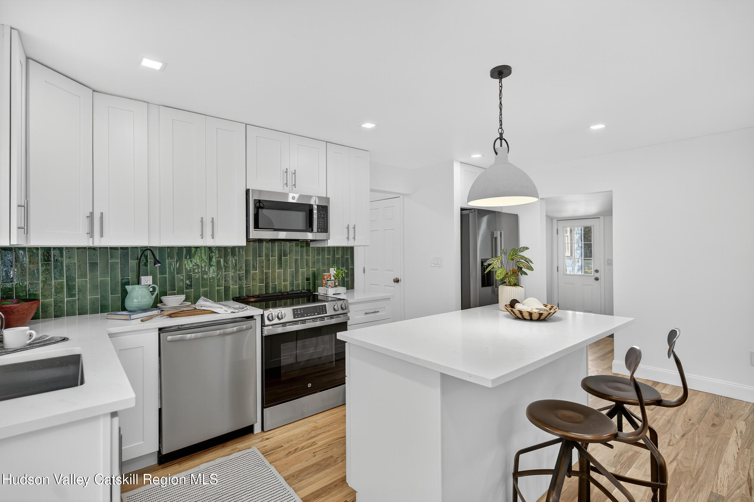 70 Fawn Road Saugerties, NY 12477 - Photo 14 of 30 a kitchen with a sink a stove and chairs
