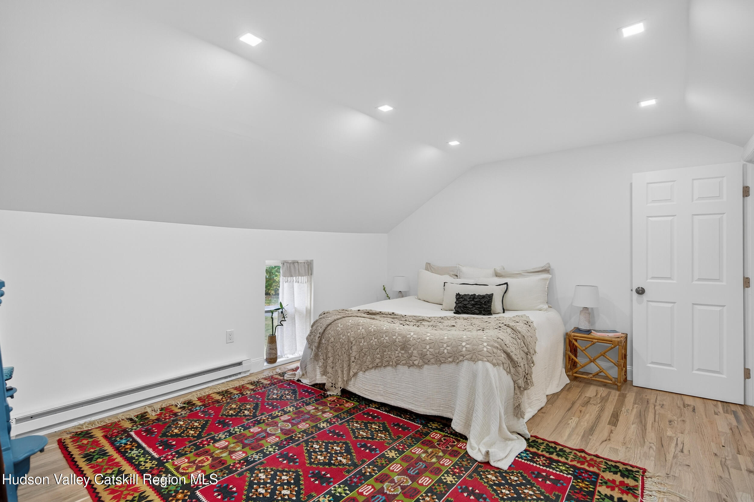 70 Fawn Road Saugerties, NY 12477 - Photo 25 of 30 a bedroom with a bed and a lamp with wooden floor