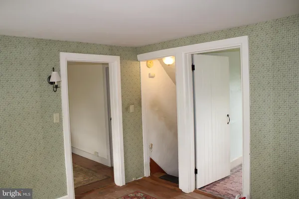 a view of a hallway with wooden floor