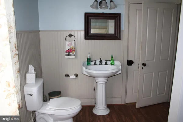 a bathroom with a toilet sink and mirror