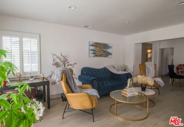 a living room with furniture and a potted plant