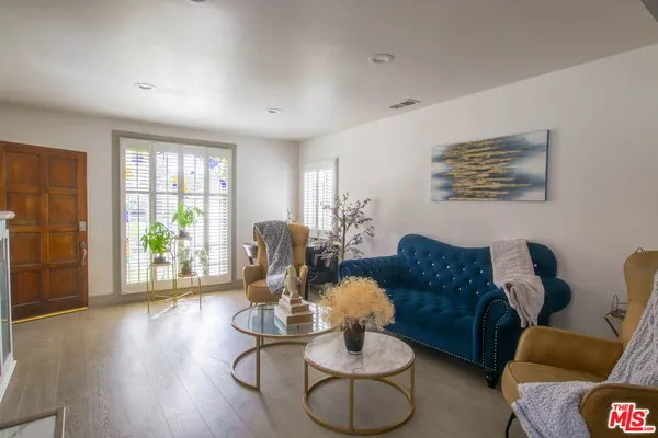 a living room with furniture fireplace and a large window