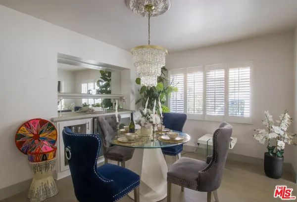 a kitchen with a dining table and chairs