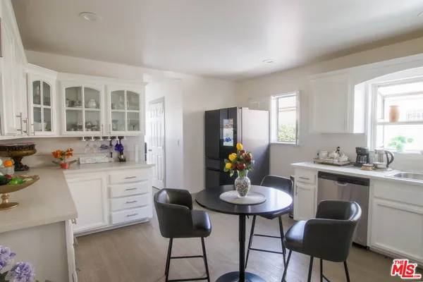 a dining room with furniture and a kitchen view