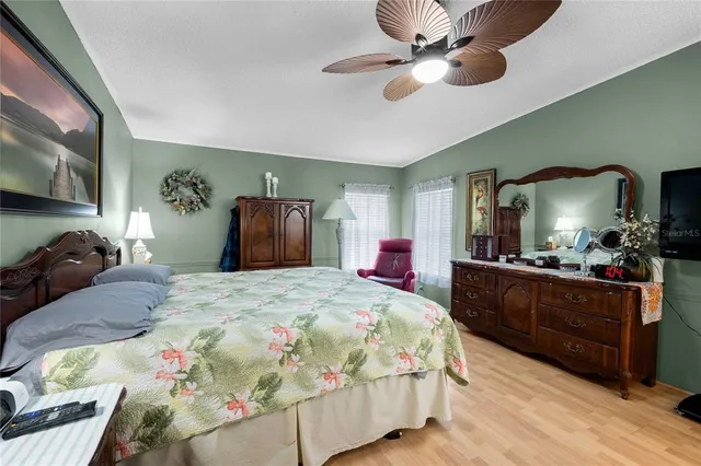 a bedroom with a bed and a mirror on dresser