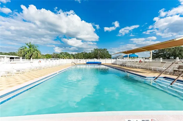 a view of a swimming pool with a patio