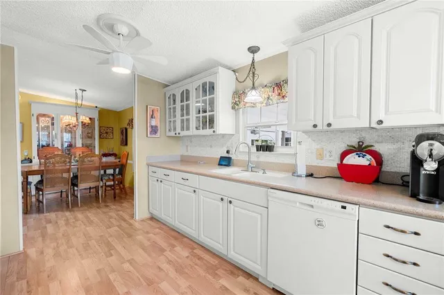 a kitchen with sink cabinets and dining table