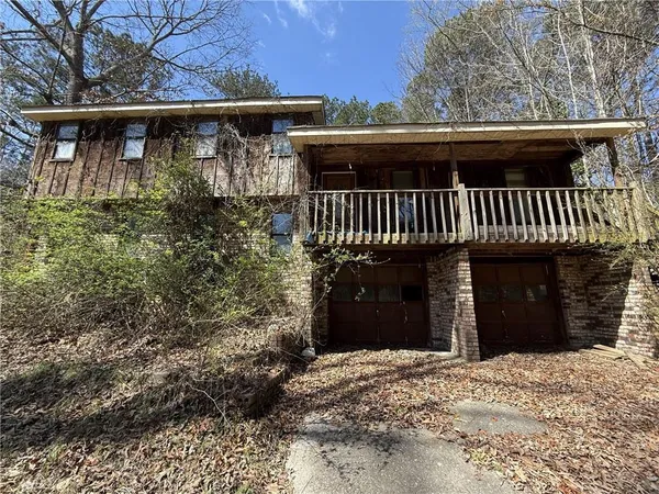 a view of a house with a yard and garage