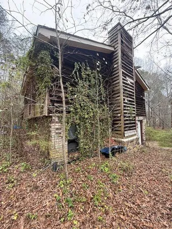 a view of a wooden house with a yard