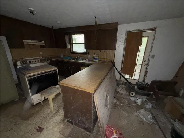 a kitchen that has a sink and a stove in it