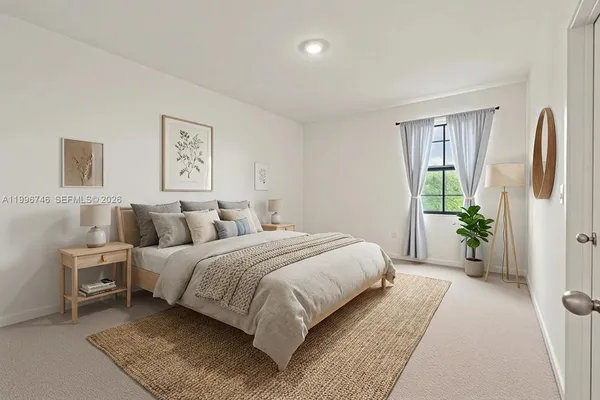 a bedroom with a bed and painting on the wall