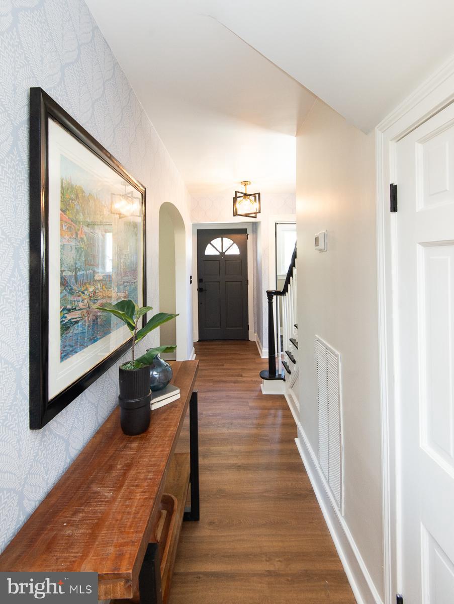 310 Talbot Avenue Cambridge, MD 21613 - Photo 18 of 68 a view of a hallway with wooden floor and stairs