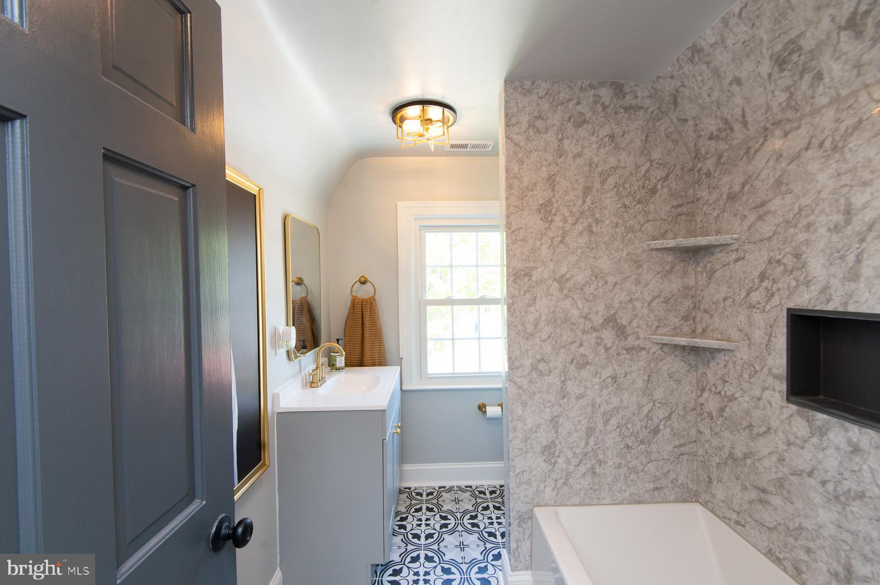 310 Talbot Avenue Cambridge, MD 21613 - Photo 34 of 68 a bathroom with a sink a toilet and mirror