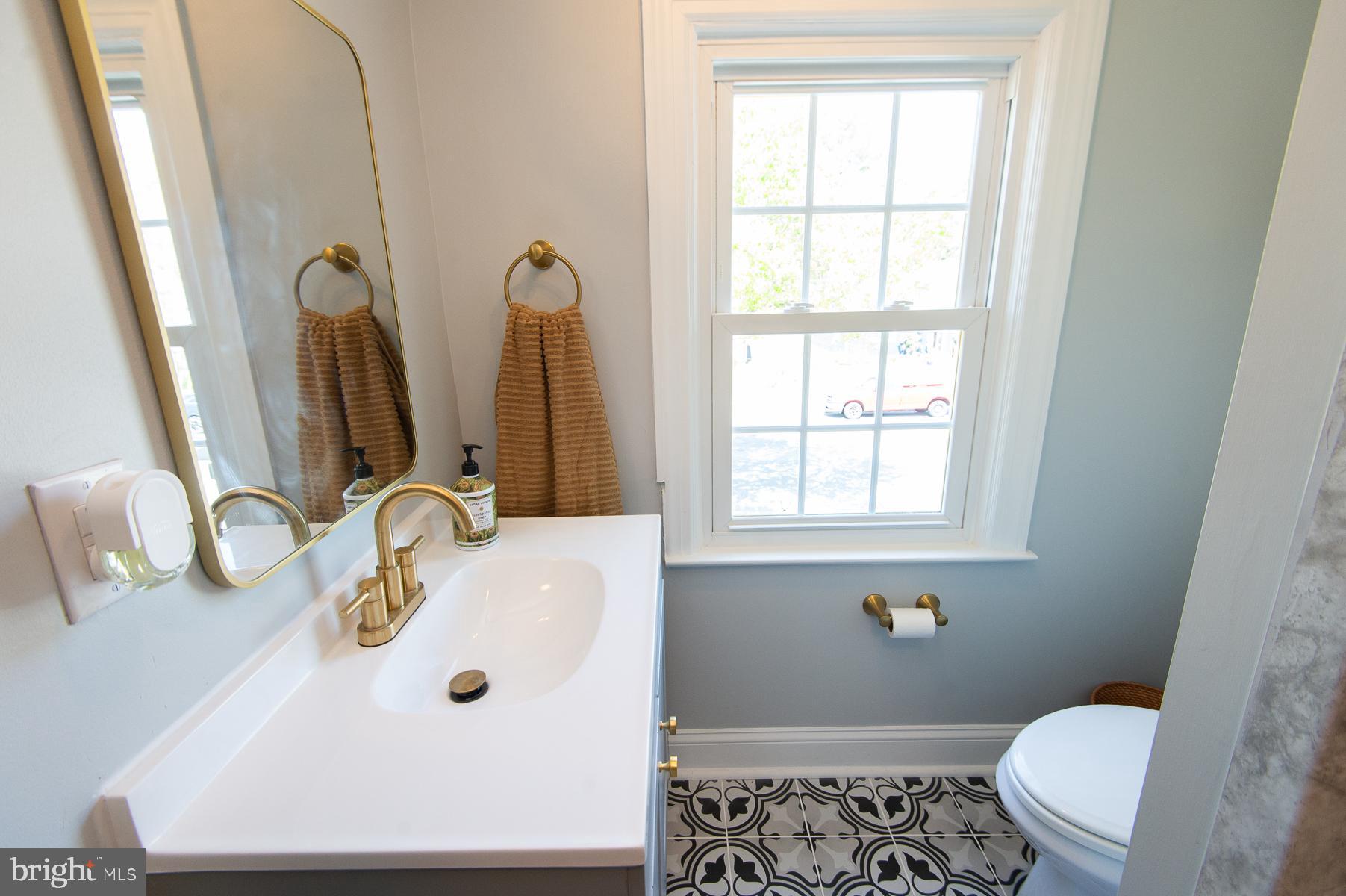 310 Talbot Avenue Cambridge, MD 21613 - Photo 35 of 72 a bathroom with a sink and a mirror